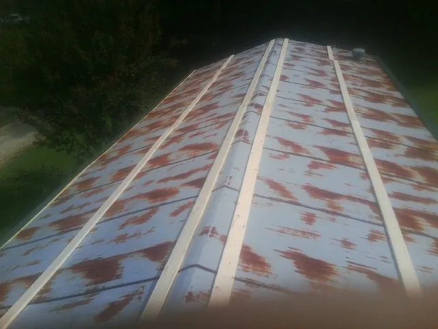 Rusted metal roof panels with new wood purlins before replacement — Storm Damage Roof Repair in Dunlap by Roofing Brothers
